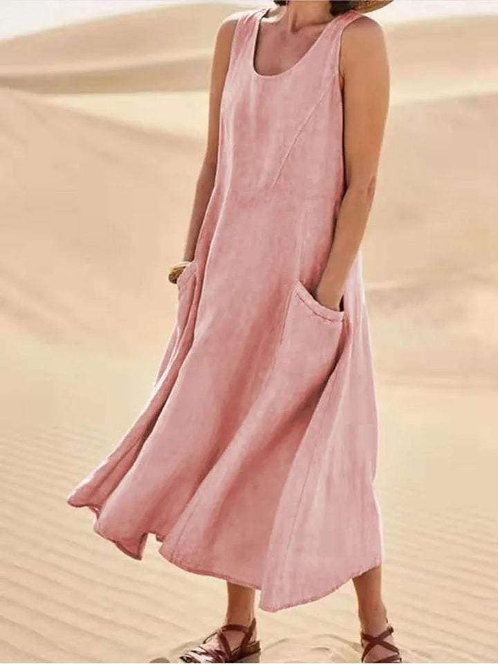 Pink maxi dress with side pockets, model in three-quarter turn