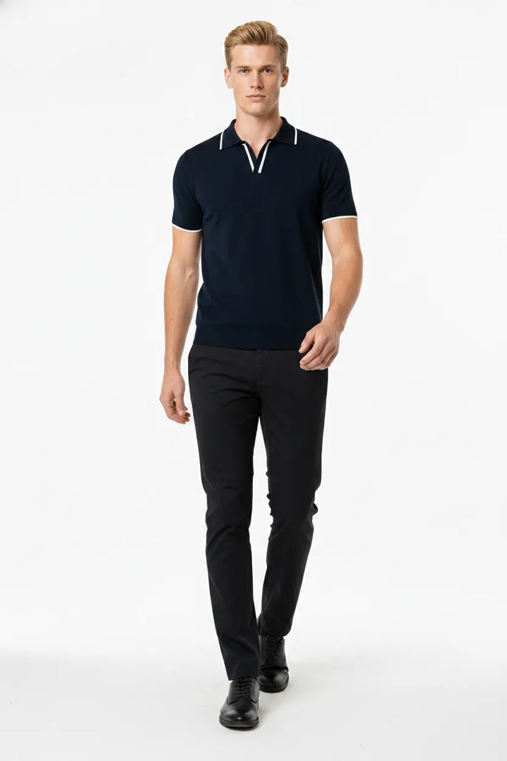 Navy blue knit polo with contrast trim, model in natural movement