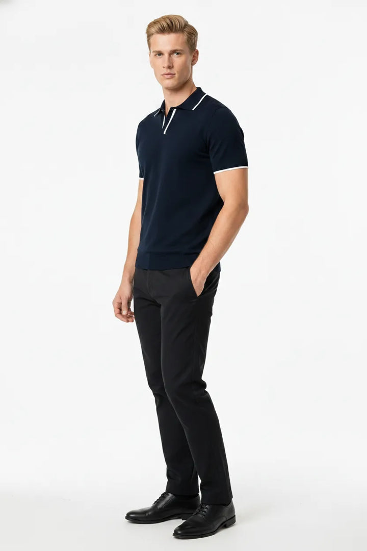 Navy blue knit polo with contrast trim, model in three-quarter turn