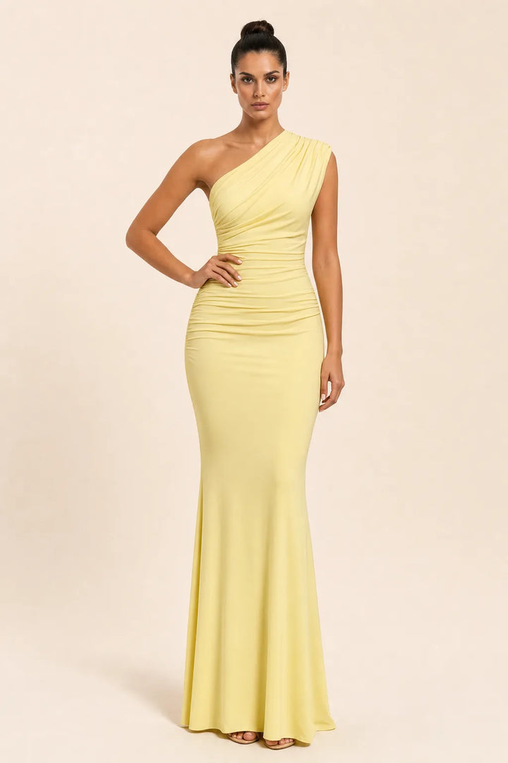 Floor-length yellow one-shoulder gown on a model in a contrapposto stance