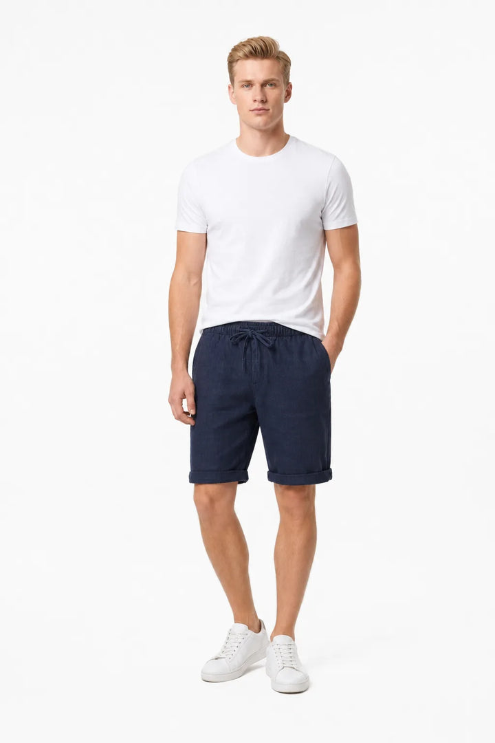 Navy blue linen drawstring shorts on a model in a contrapposto stance