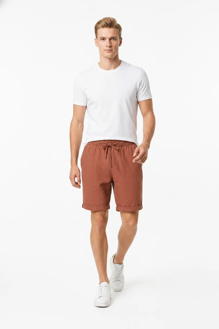 Orange linen drawstring shorts on a model in natural movement