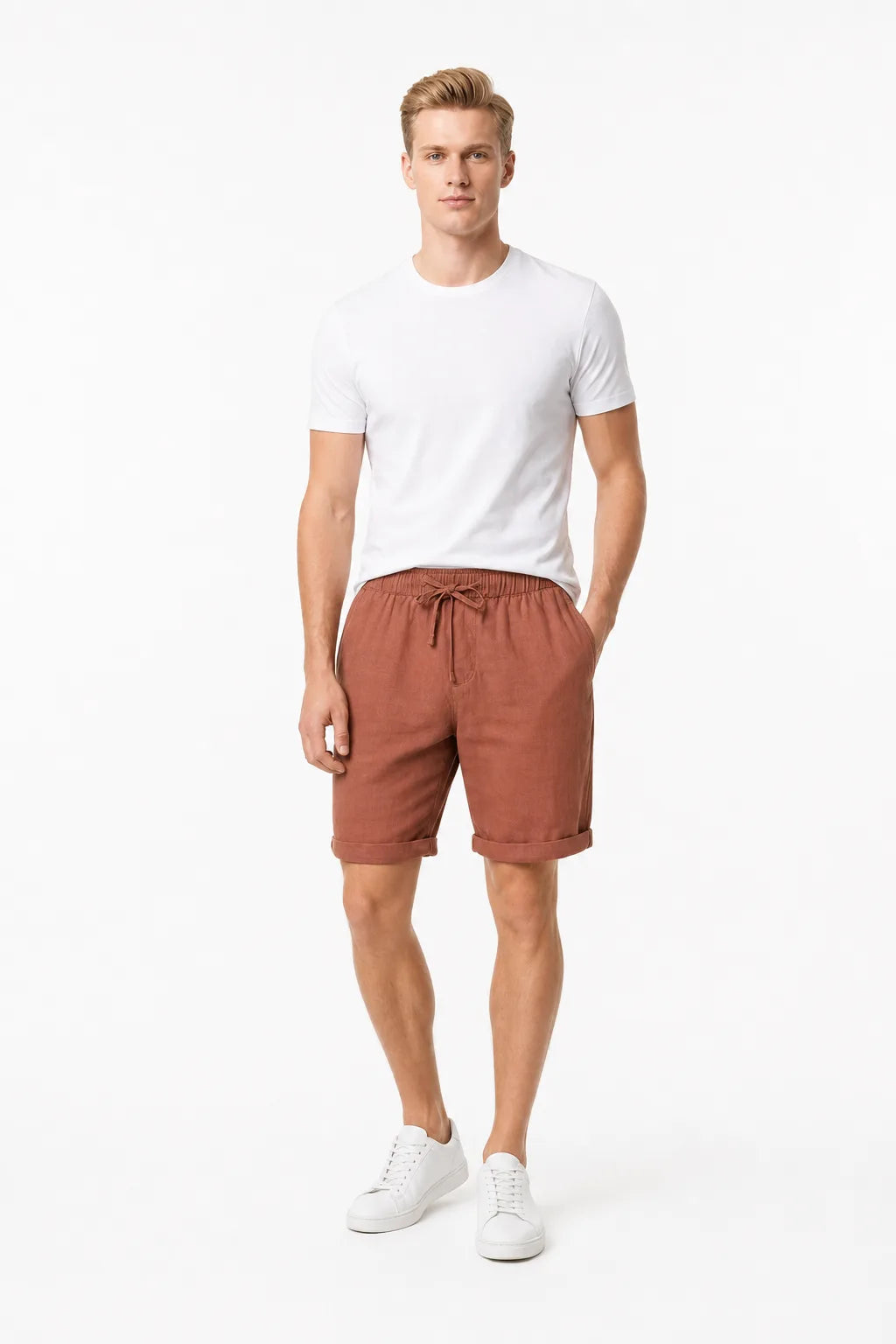 Orange linen drawstring shorts on a model in a contrapposto stance
