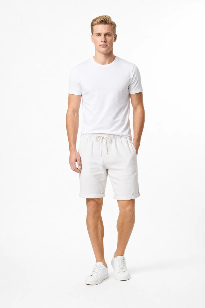 White linen drawstring shorts on a model in a contrapposto stance