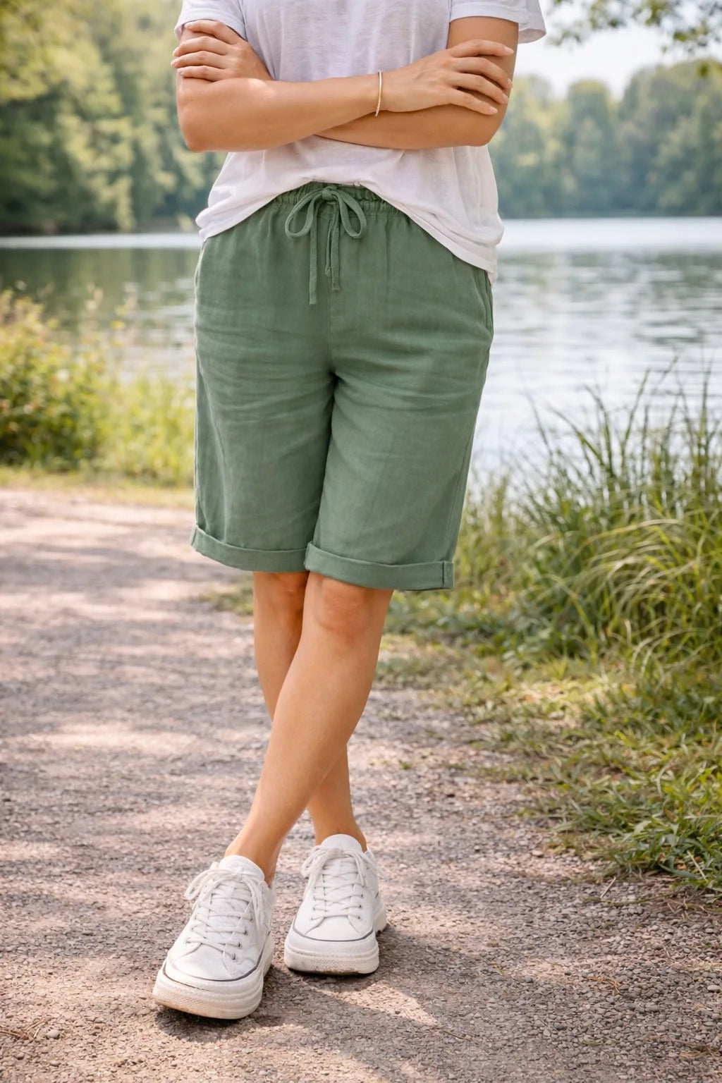 Green drawstring Bermuda shorts on model, side view