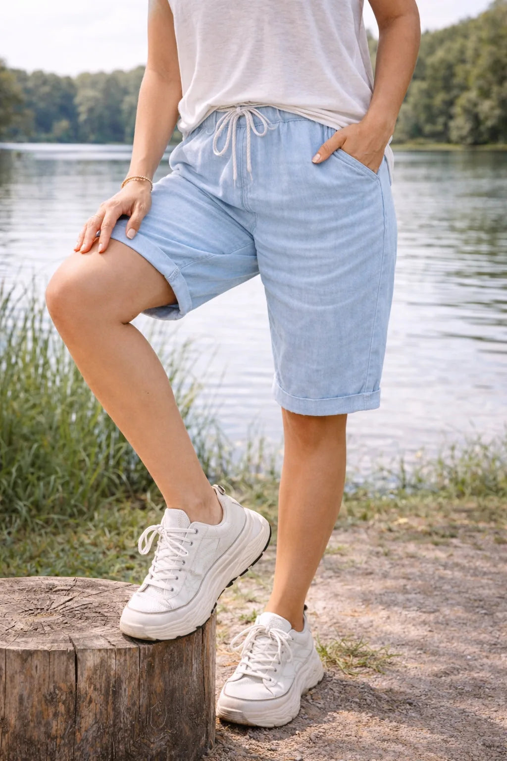 Sky blue drawstring Bermuda shorts on model, styled outfit view