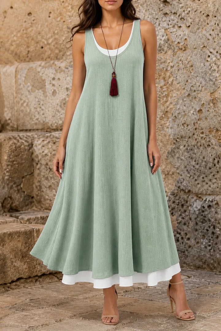 Green layered mini dress on model in contrapposto stance, front view