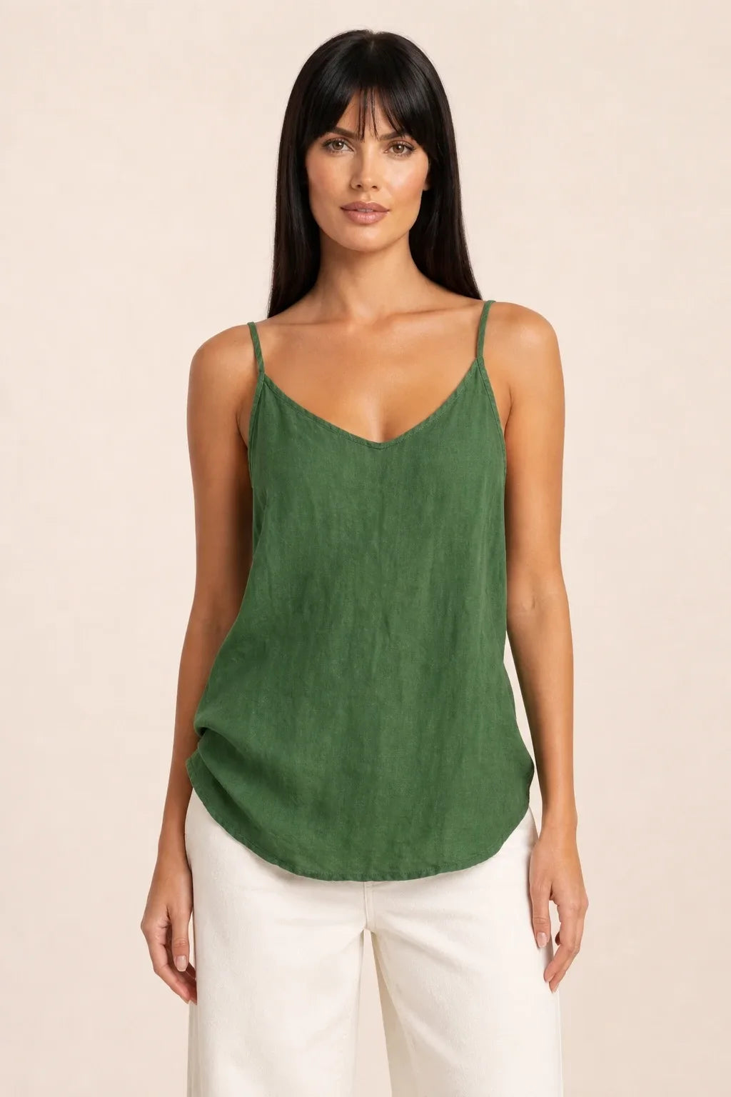 Green spaghetti strap cami on model in contrapposto stance