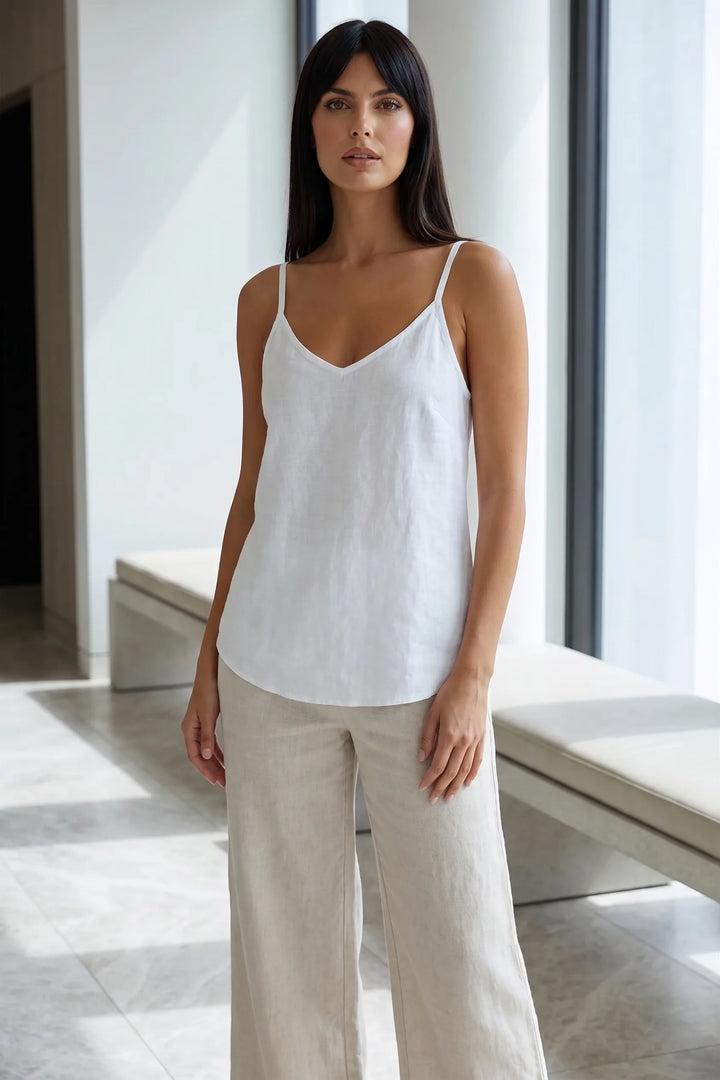 Model wearing white spaghetti strap cami in lifestyle setting