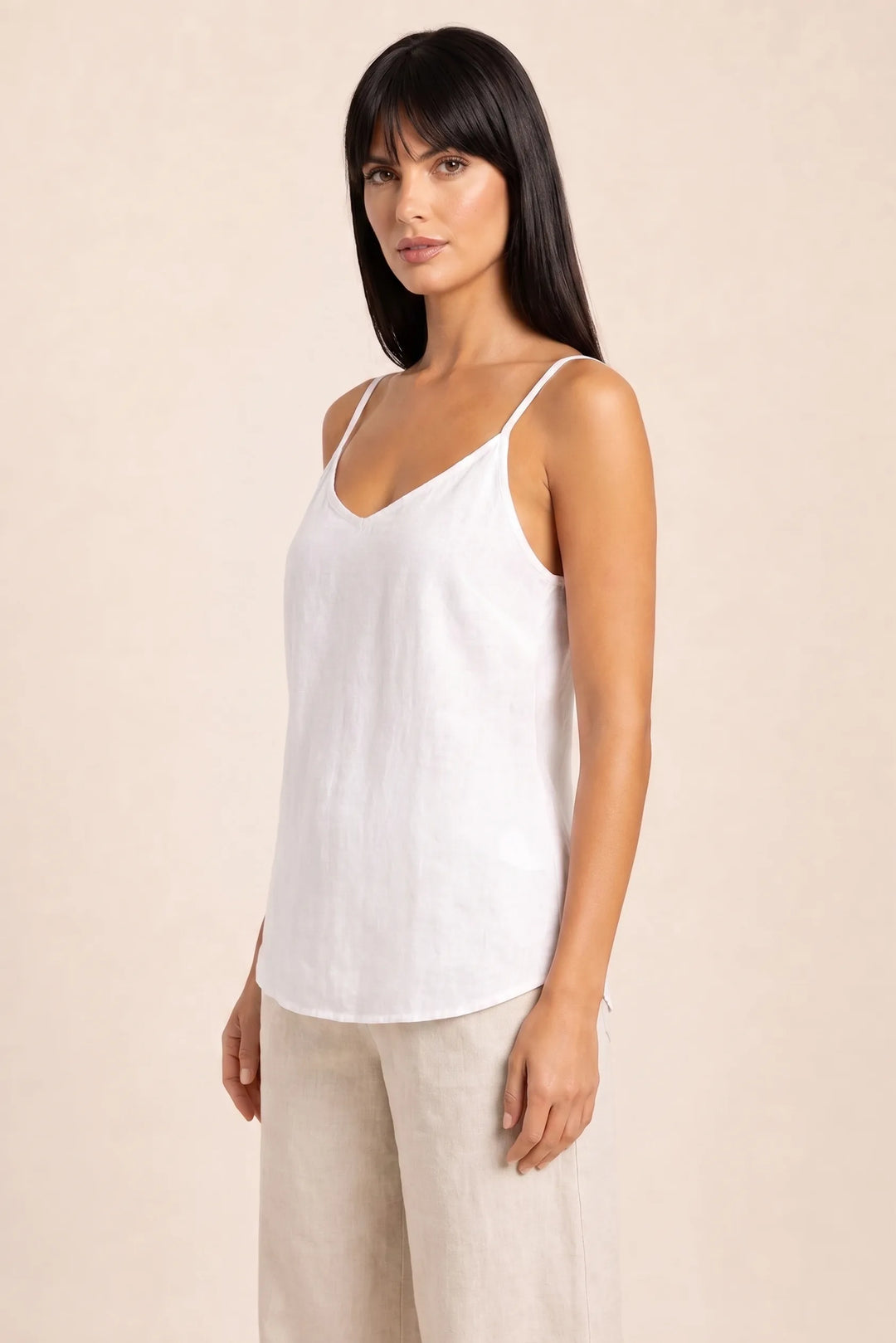 White spaghetti strap cami on model in three-quarter turn