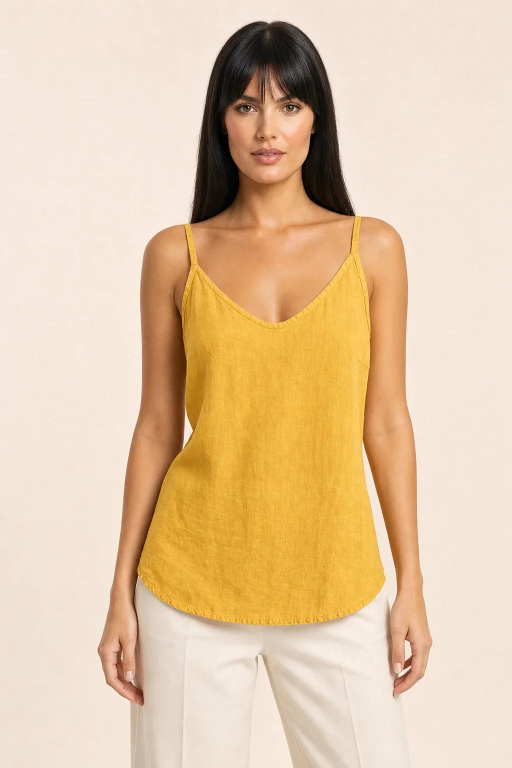 Yellow spaghetti strap cami on model in contrapposto stance