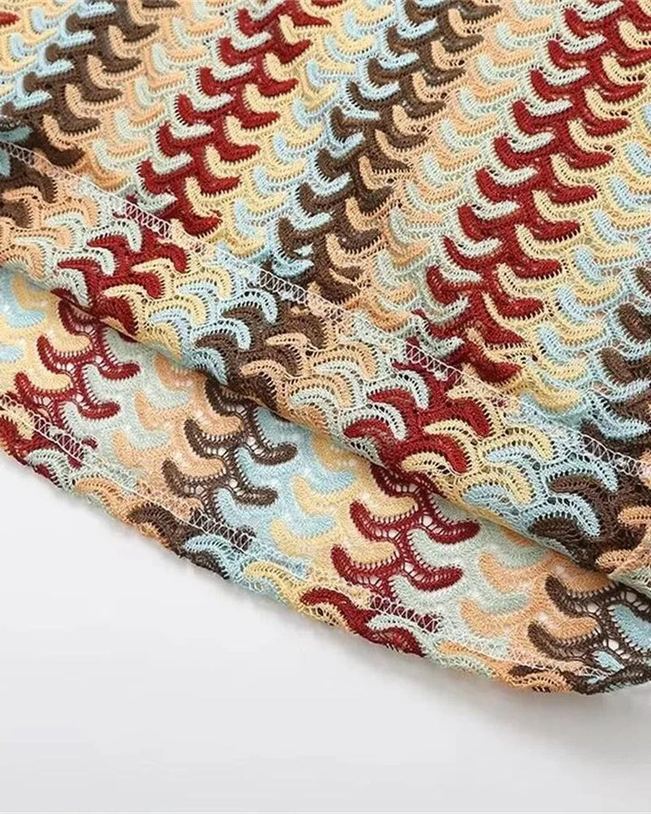 Close-up detail of a beige multicolor crochet halter maxi dress texture and pattern