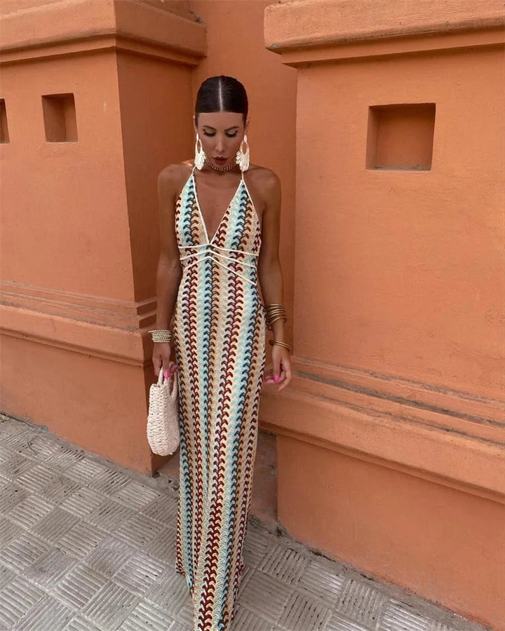 Woman wearing a beige multicolor crochet halter maxi dress, standing facing forward
