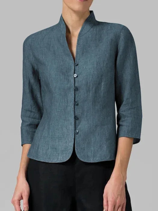 Close-up detail of a dark blue mandarin collar blouse collar and buttons