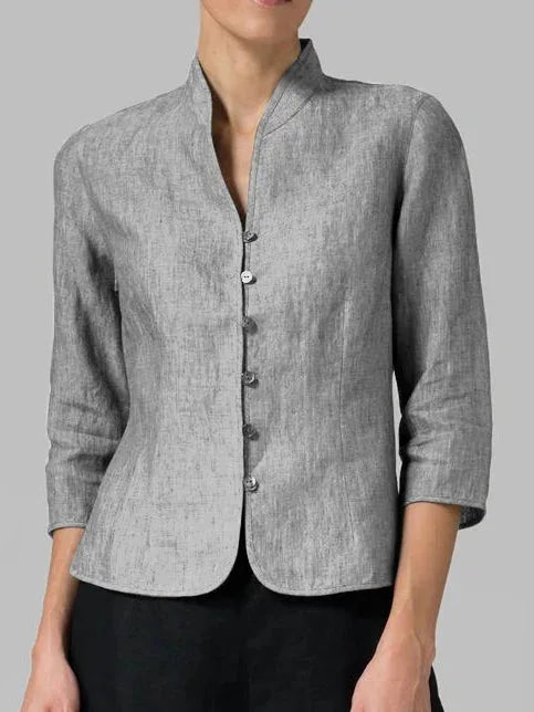 Model in side profile wearing a gray mandarin collar blouse