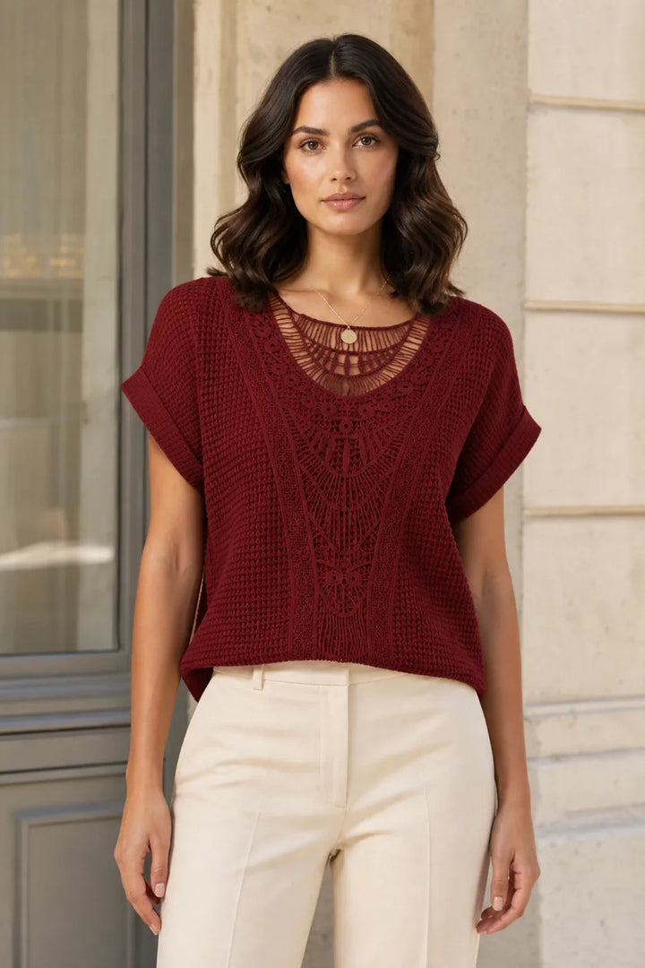 Red crochet panel top on model in contrapposto stance, front view