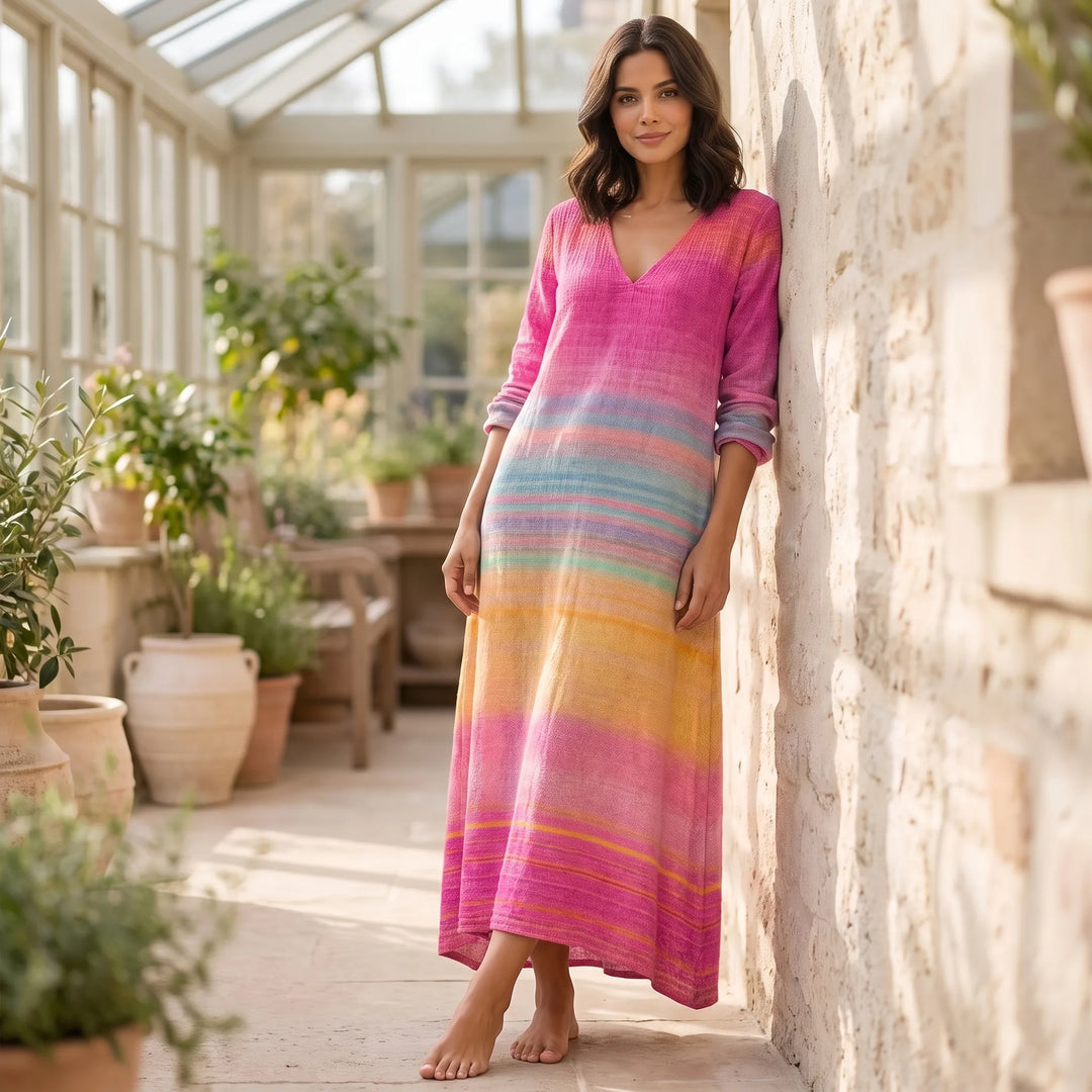 Model wearing pink gradient stripe maxi dress in outdoor lifestyle setting