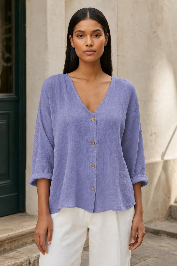 Model in a purple button-front relaxed blouse, standing in a contrapposto pose