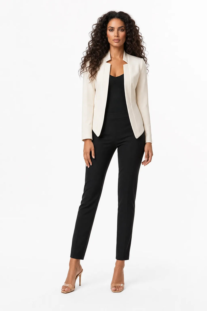 White collarless open-front blazer on a model in a contrapposto stance