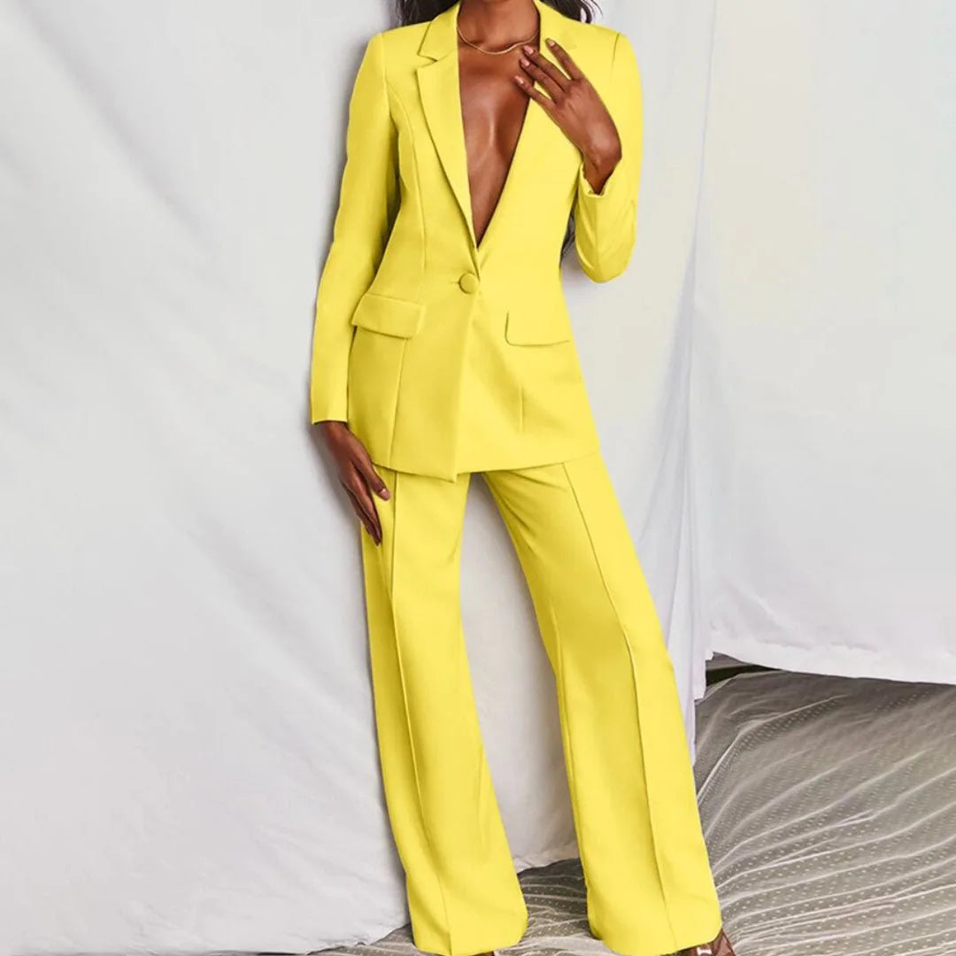 Woman wearing a yellow tailored blazer suit set, standing facing forward