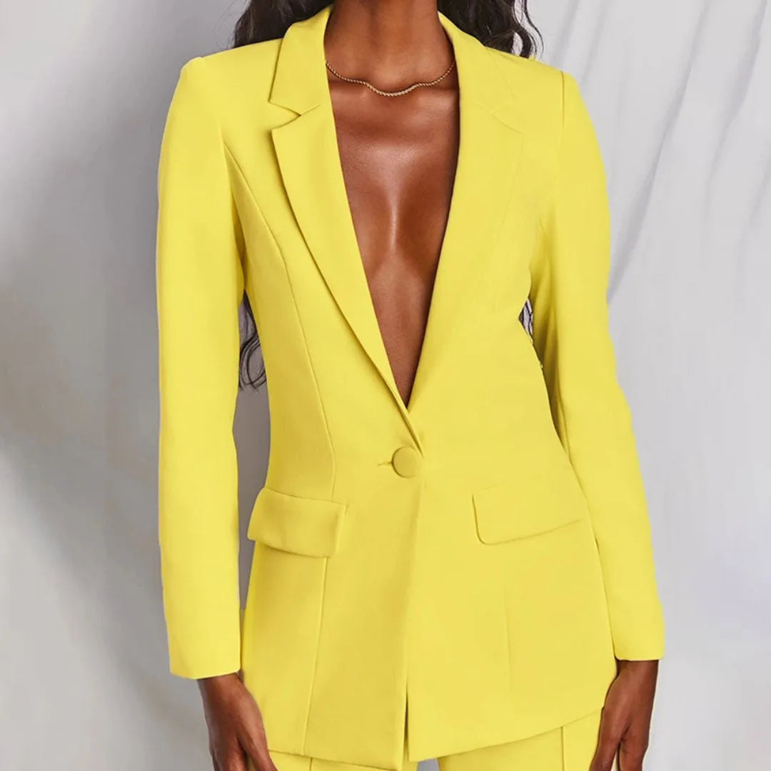 Woman in a yellow tailored blazer suit set, turned at a three-quarter angle