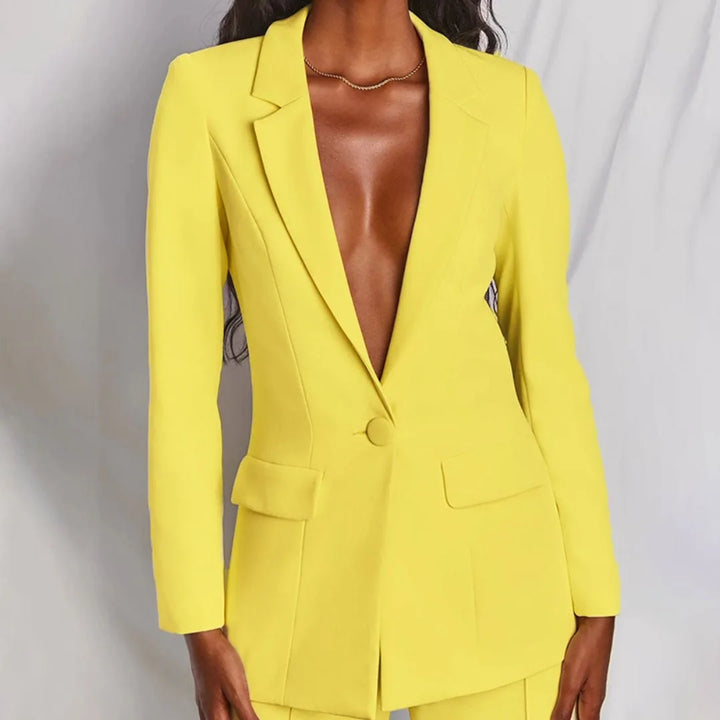 Woman in a yellow tailored blazer suit set, turned at a three-quarter angle