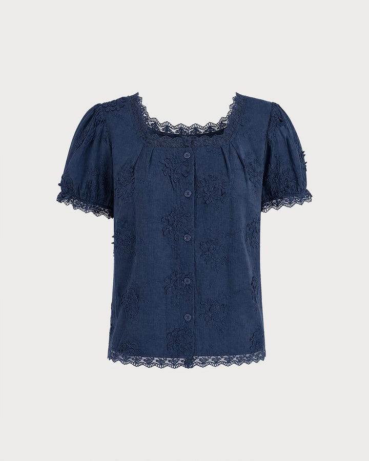 Model wearing a blue lace trim embroidered blouse, turned three-quarters to the side