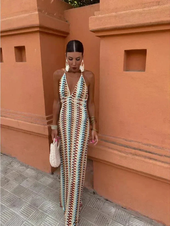 Model facing forward in a multicolor crochet halter maxi dress