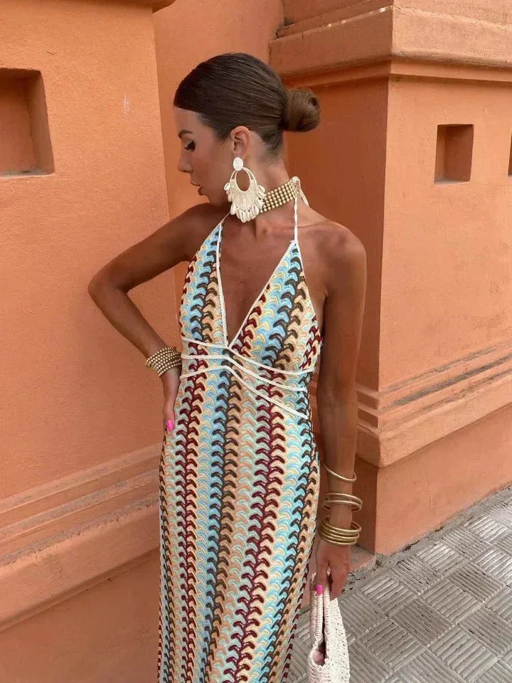Side view of model wearing a multicolor crochet halter maxi dress