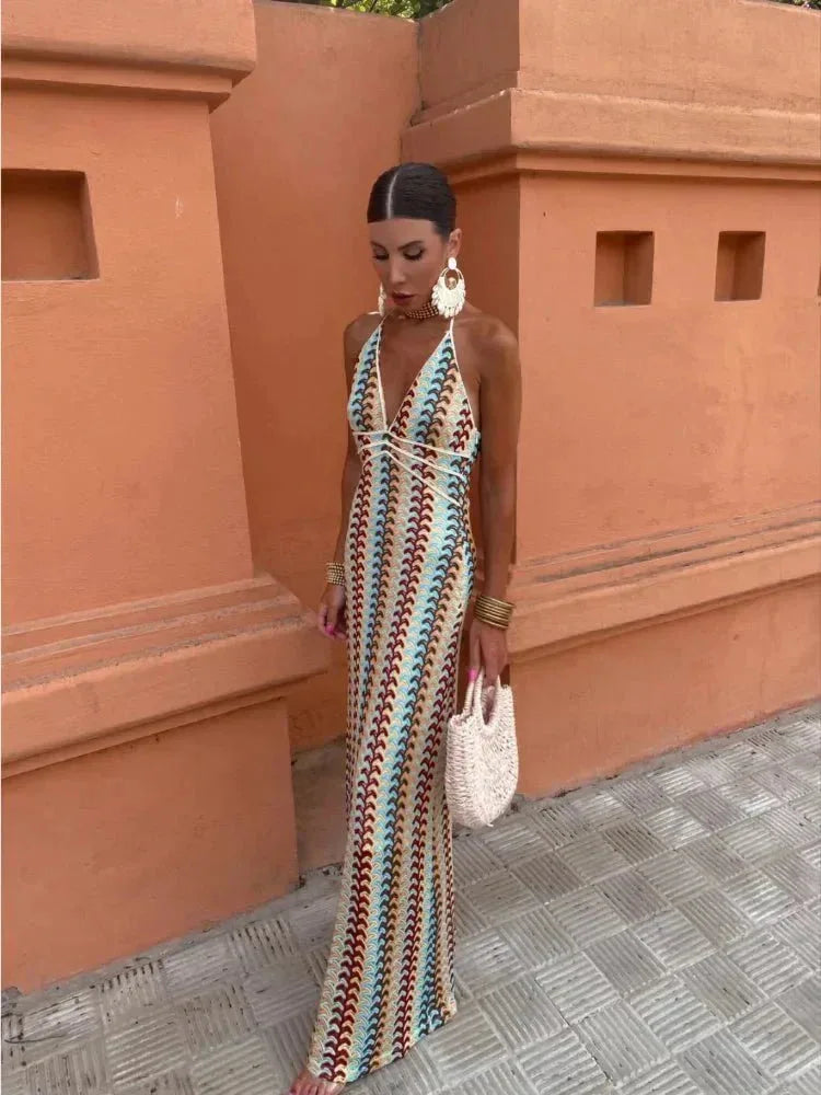 Model in a three-quarter turn wearing a multicolor crochet halter maxi dress