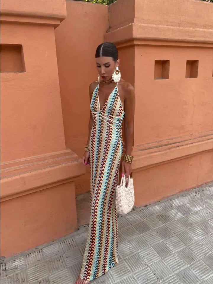Model in a three-quarter turn wearing a multicolor crochet halter maxi dress