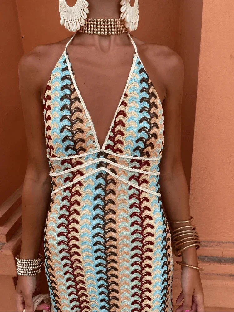 Model posing in a multicolor crochet halter maxi dress