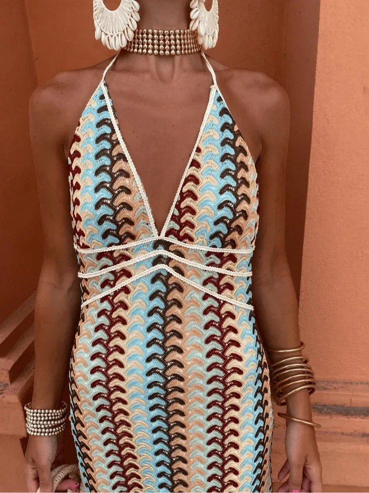 Model posing in a multicolor crochet halter maxi dress