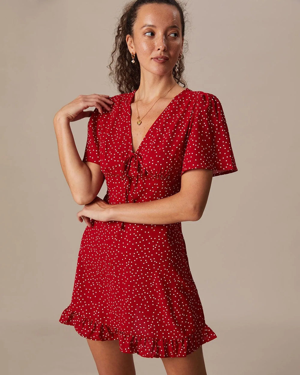 Close-up of the tie-front knot detail on a red mini dress