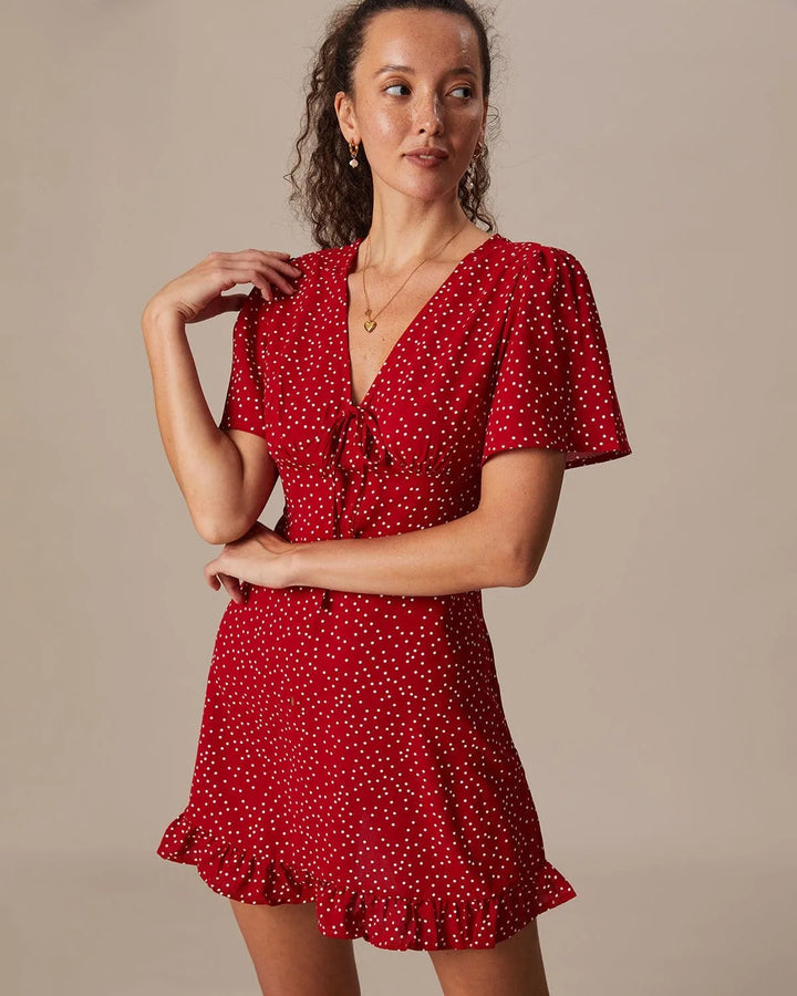 Close-up of the tie-front knot detail on a red mini dress