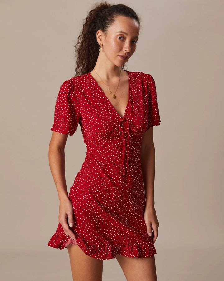 Model facing forward wearing a red tie-front mini dress with a front knot detail
