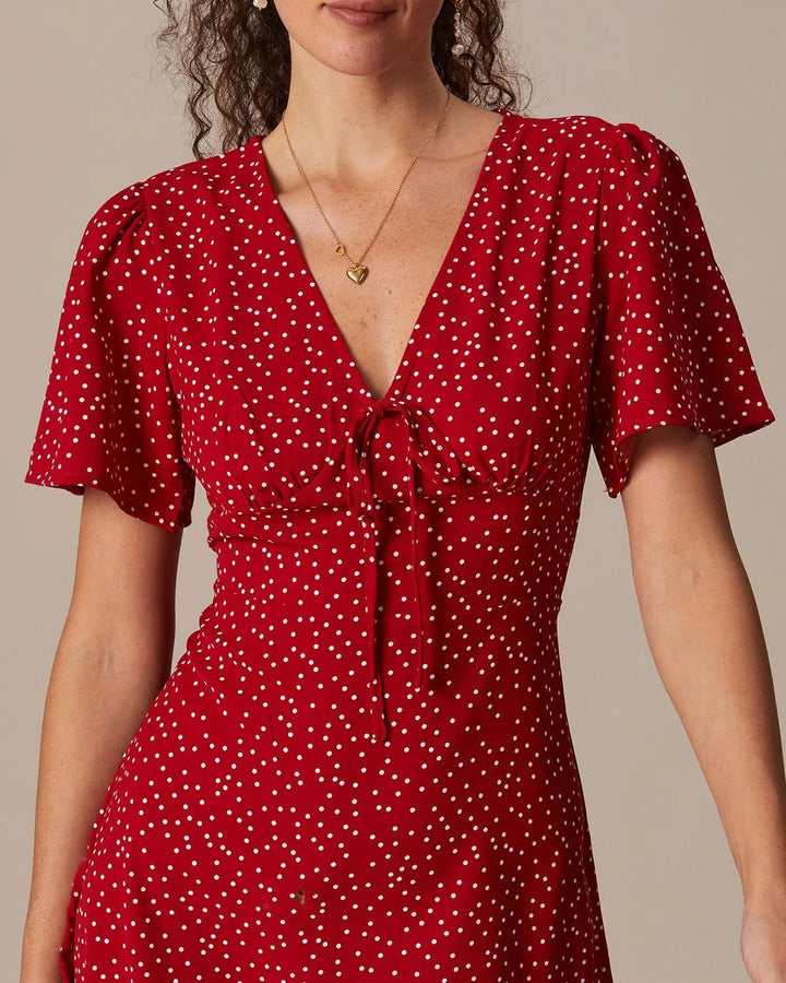 Model at a three-quarter turn in a red tie-front mini dress showing silhouette and knot