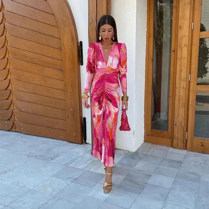 Close-up of ruched fabric detail on a pink printed midi dress