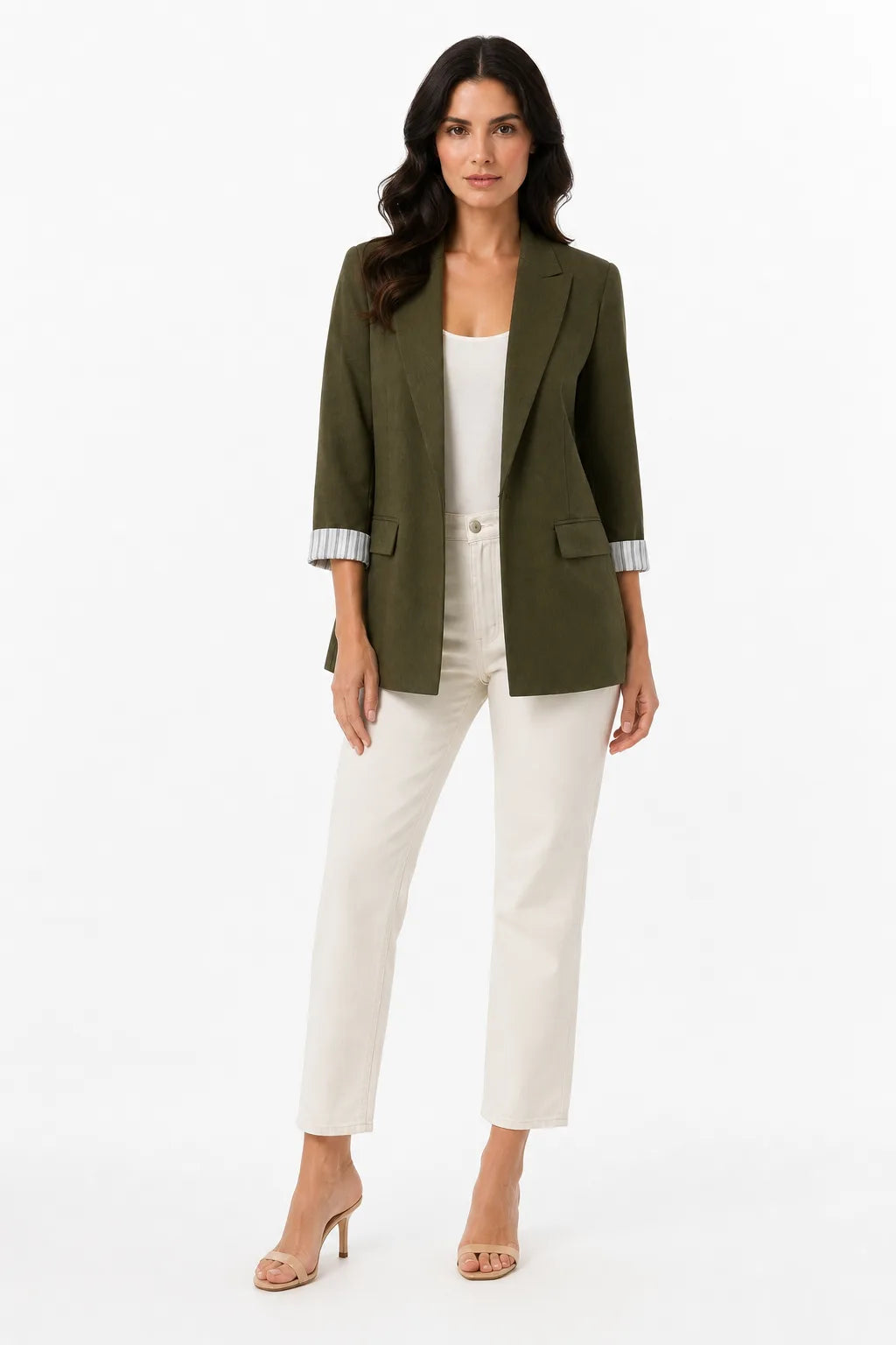Green longline blazer with cuffed sleeves on a model in a contrapposto stance