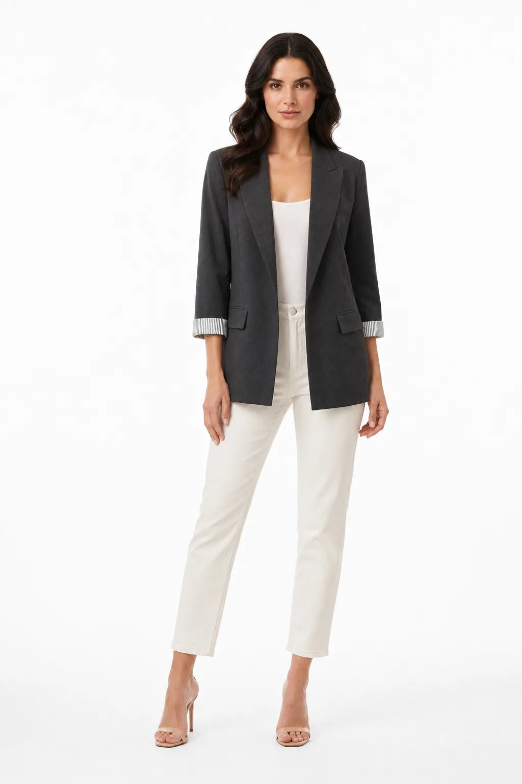 Grey longline blazer with cuffed sleeves on a model in a contrapposto stance