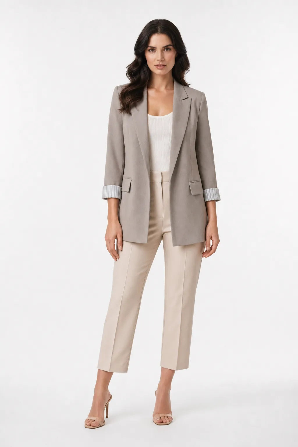 Khaki longline blazer with cuffed sleeves on a model in a contrapposto stance