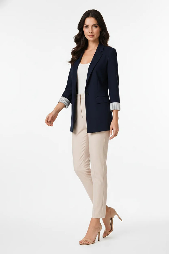 Navy blue longline cuffed blazer on a model captured mid natural movement