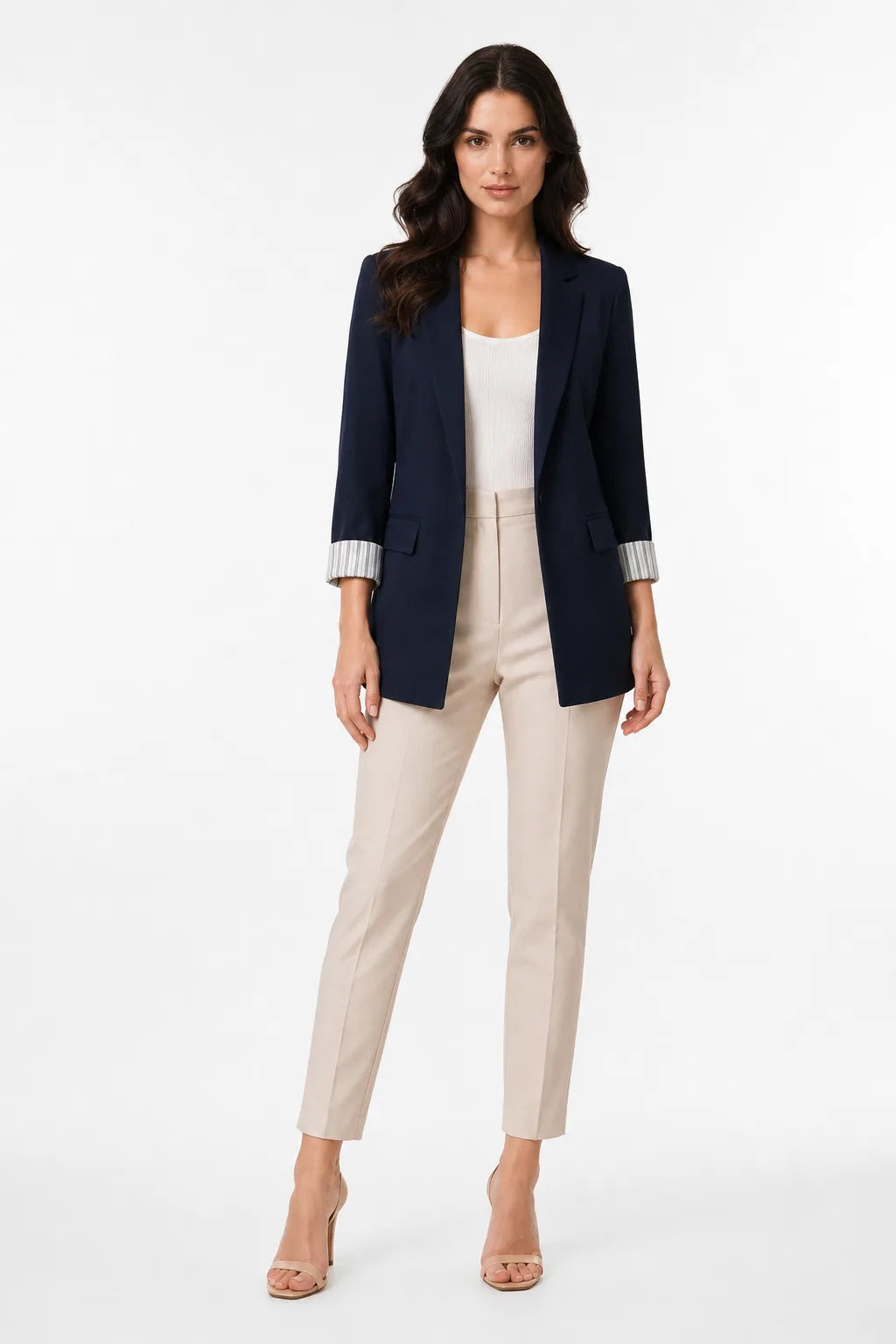Navy blue longline blazer with cuffed sleeves on a model in a contrapposto stance