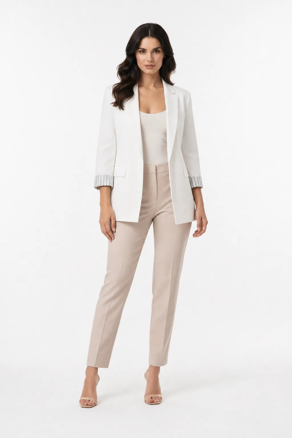 White longline blazer with cuffed sleeves on a model in a contrapposto stance