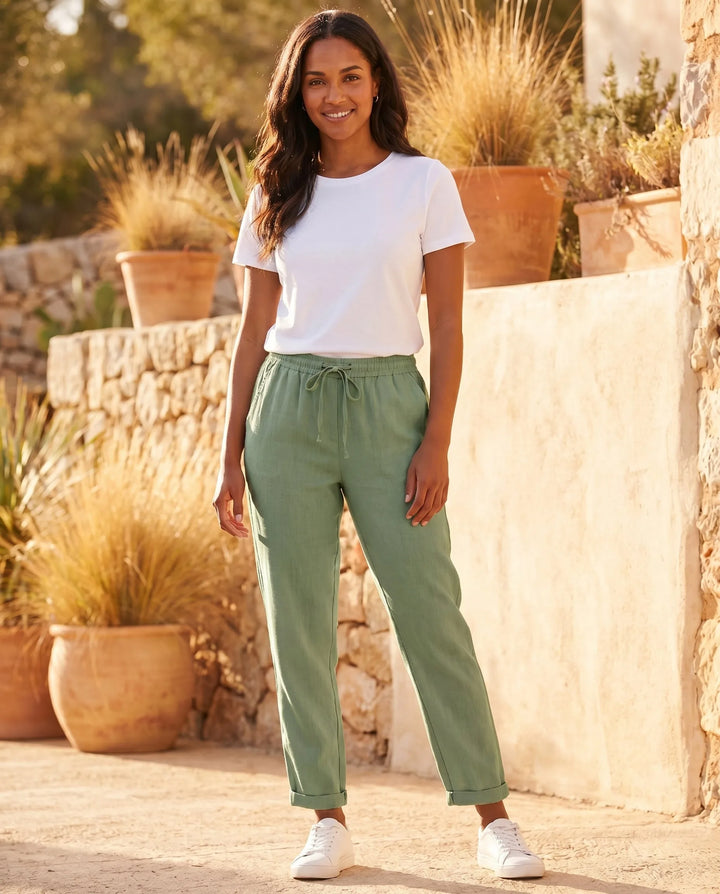Beige drawstring tapered pants on model highlighting overall drape and fit