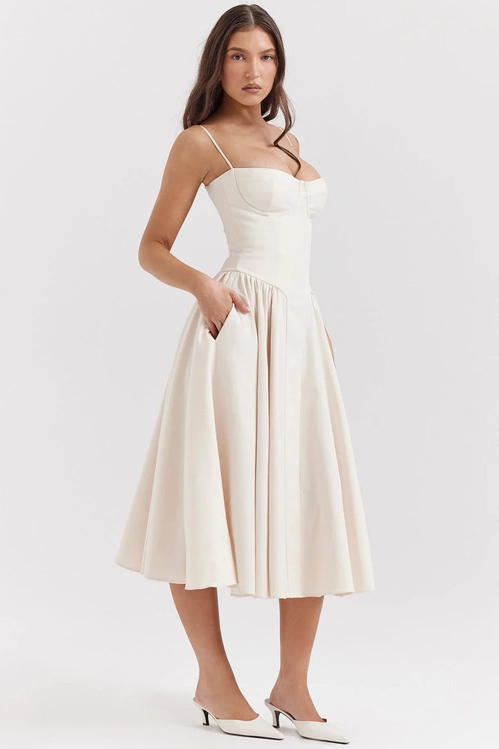Close-up detail of a beige corset midi dress showing boning and fabric texture