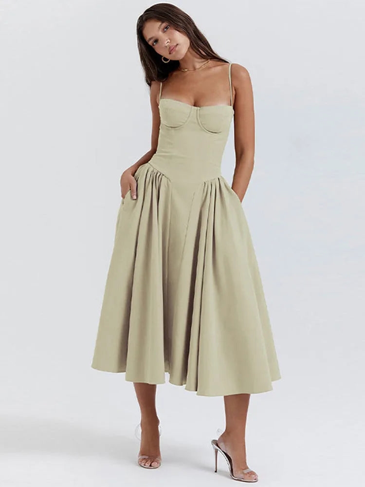 Model at a three-quarter turn wearing a green corset midi dress with boned bodice