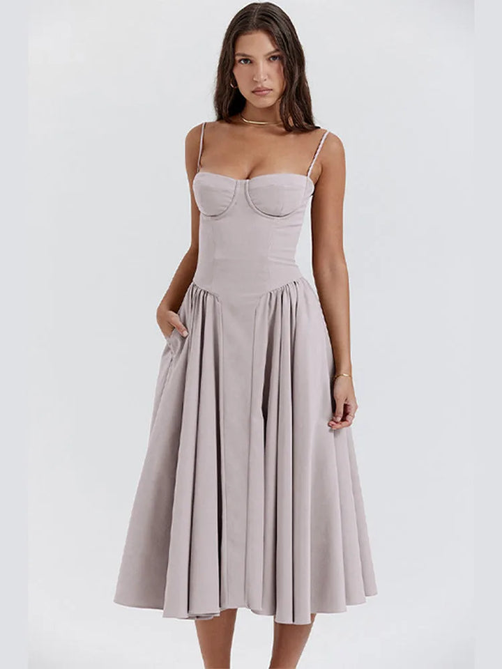 Model wearing a light grey corset midi dress with fitted boned bodice and midi skirt