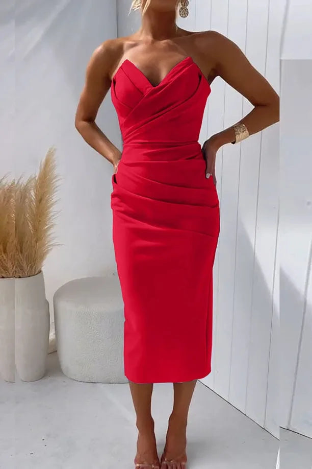 Model in side profile wearing a red strapless ruched midi dress