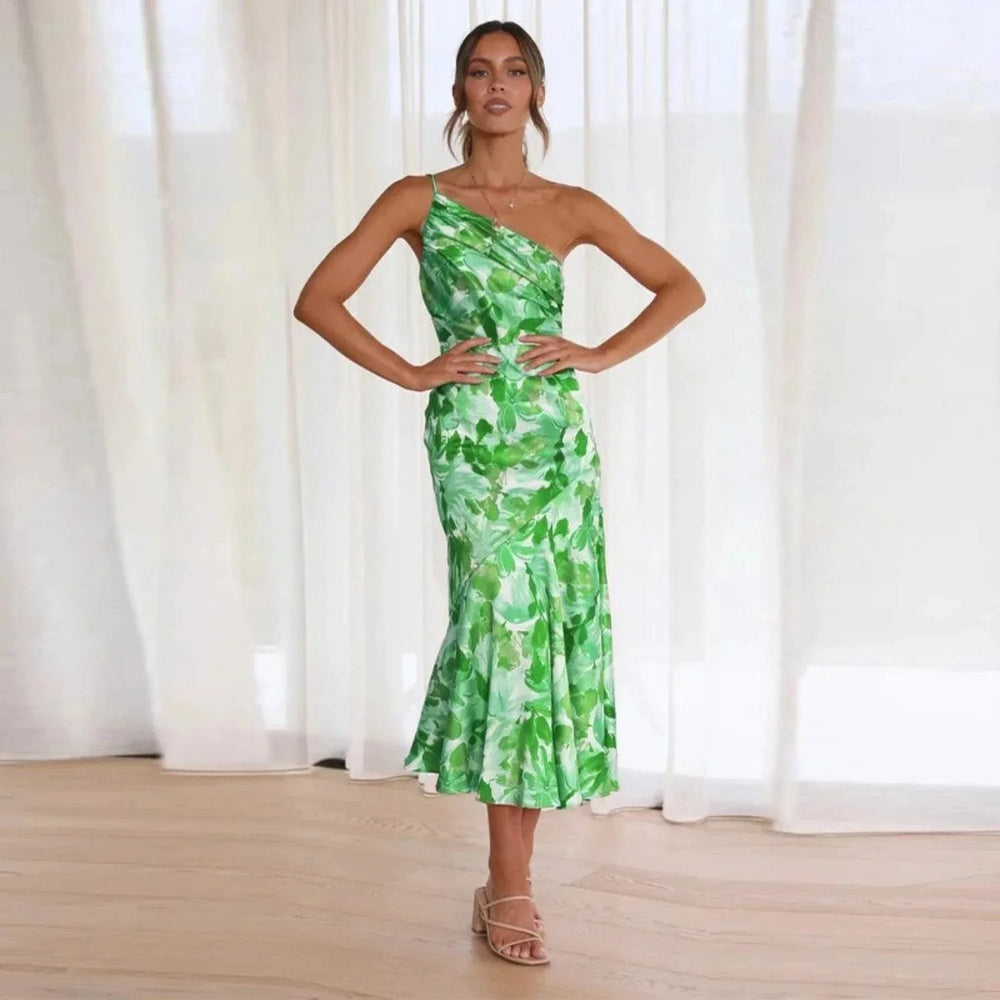 Close-up detail of green floral one-shoulder midi dress fabric and print